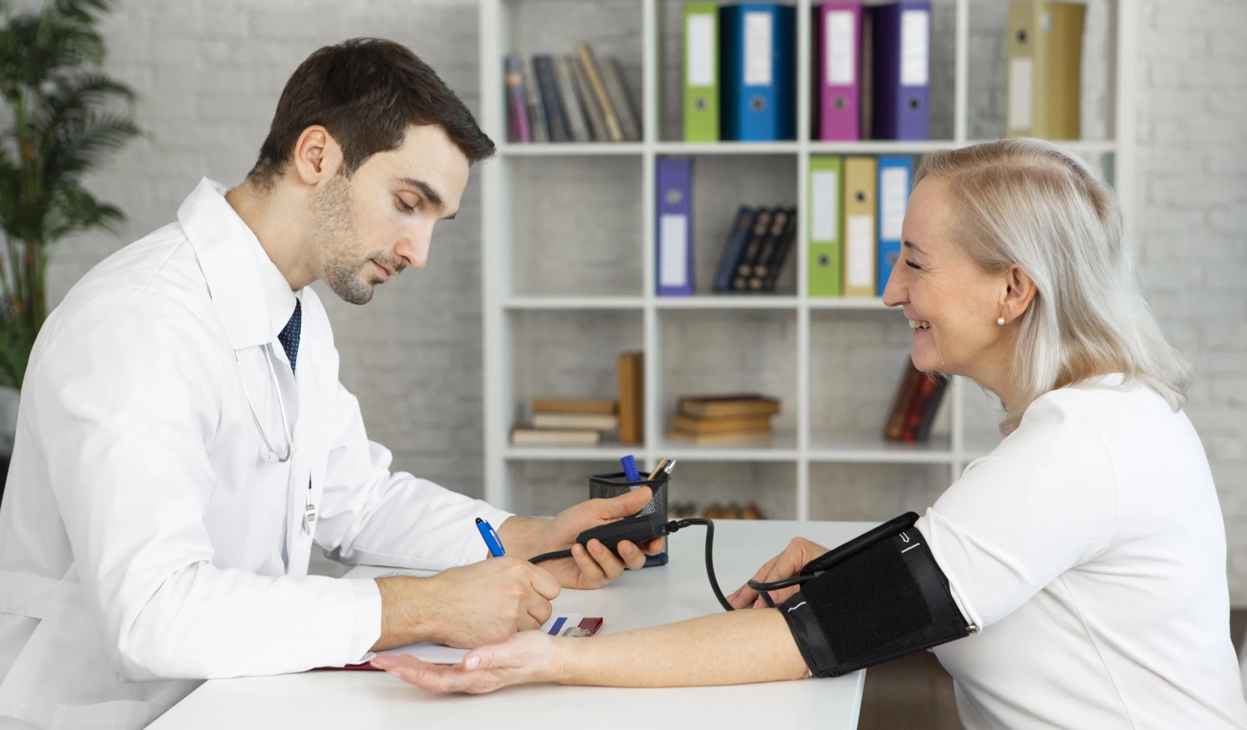 medium-shot-doctor-taking-blood-pressure