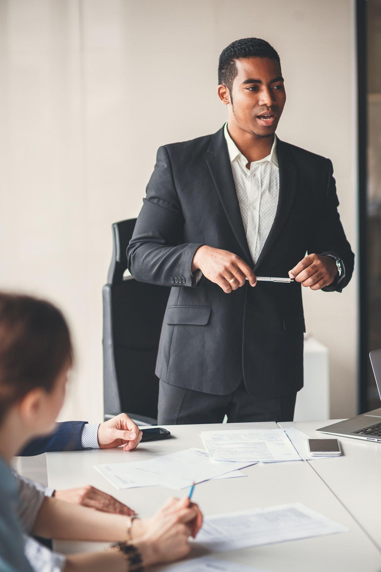 Portrait of smiling young african business man in glasses in business meeting