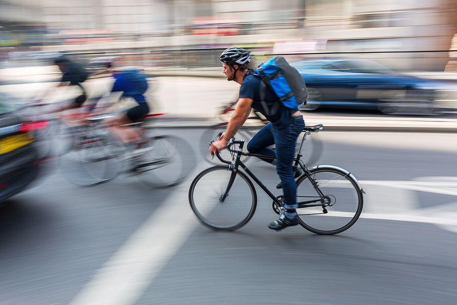 London UK - June 15 2016: cyclist in London city traffic in motion blur. Cycling is an increasingly popular way to get around London